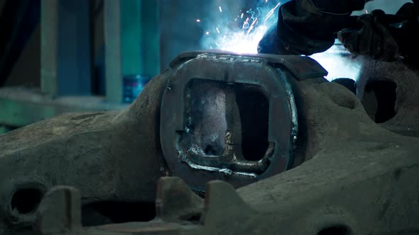 Heavy Industry Welder Welds Metal Parts for Car Repair alt