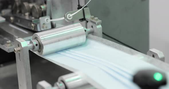 Stainless Steel Roller Of A Machine Pressing Medical Mask Fabric With Folded Pleats. static wide sho alt