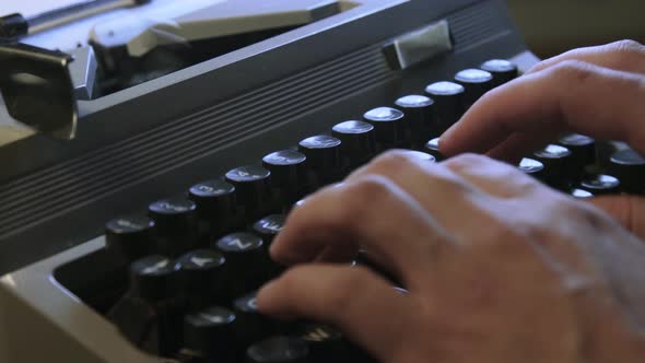 A man typing on a typewriter