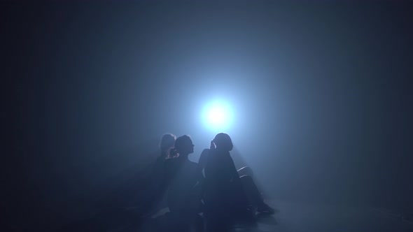 Silhouettes of Professional Ballerinas Dancing in Haze of Studio. alt