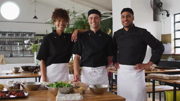 Diverse group of chefs looking at the camera and smiling alt