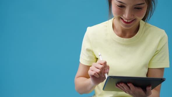 Young girl using digital tablet looking at empty space isolated . alt
