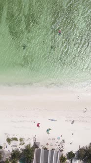 Vertical Video Kitesurfing Near the Shore of Zanzibar Tanzania alt