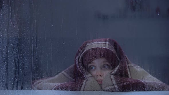Scared Little Girl Covering With Blanket Frightened by Thunder on Rainy Day alt