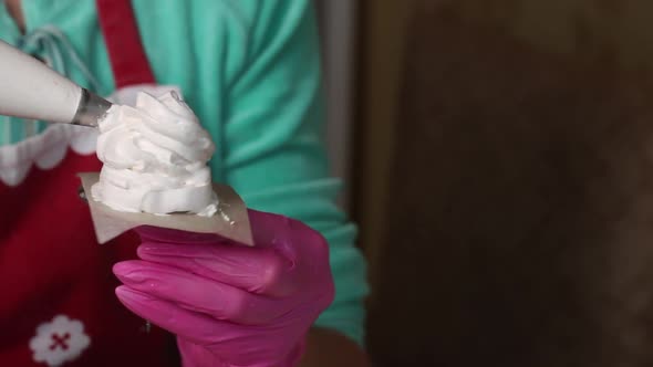 Woman Makes Marshmallow Cones. Using A Pastry Bag. Close Up Shot alt