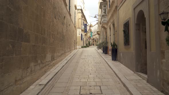 Long Narrow Empty Yellow Stone Street with Old Historic Houses in Birgu