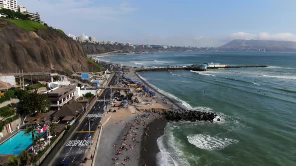 4k aerial daytime panoramic video of the Makaha beach in Miraflores and the La Rosa Nautica on the c alt