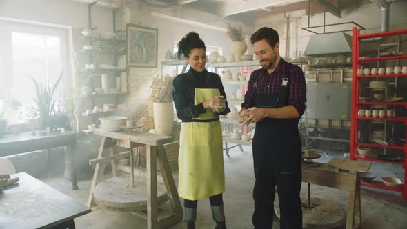 Woman and Man Work with Raw Clay