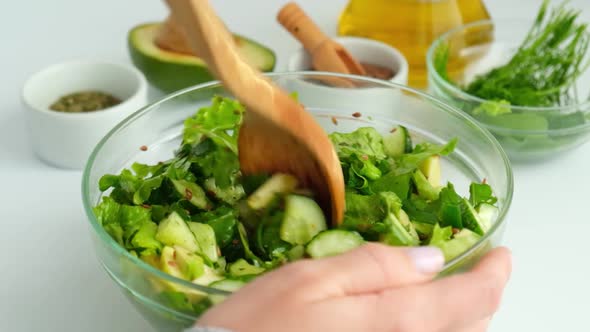 Woman Mix Salad of Fresh Green Vegetables and Herbs alt