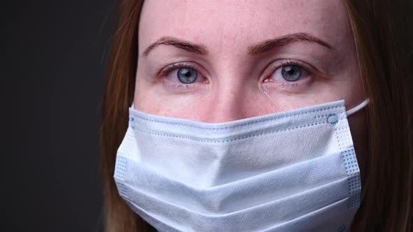 The Masked Girl Turns Around and Looks Into the Camera. Epidemic of the Covid-19 Virus in China and