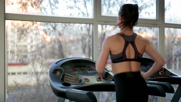 Successful Young Lady Training on Treadmill in Gym, Working Hard to Achieve Goal alt
