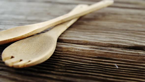 Wooden spoon and fork on table alt