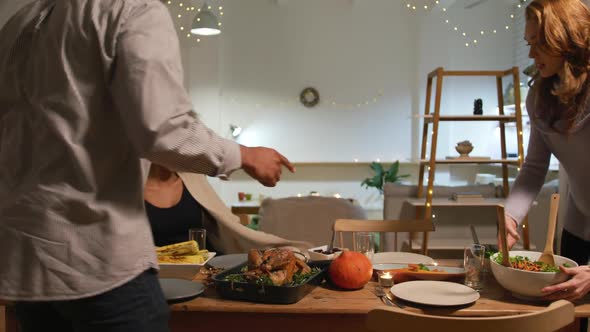 Millennial adult friends celebrating Thanksgiving together at home alt