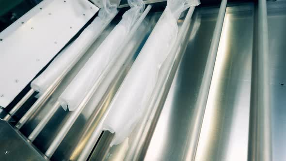 Stacks of Transparent Cups Packaging Into Plastic Bags alt