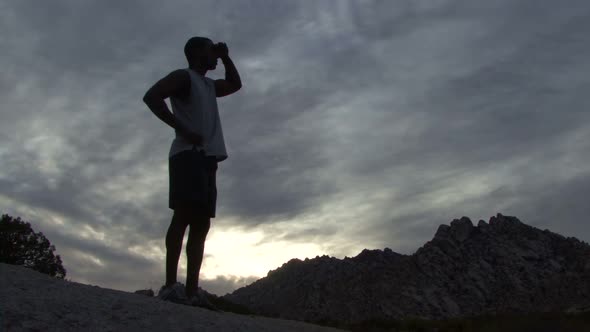Male on rock looking into distance alt