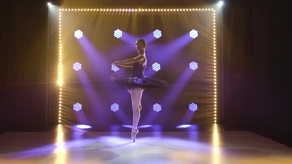 Young Flexible Ballerina in Black Tutu and Pointe Ballet Shoes. Graceful Dancing of Elements alt
