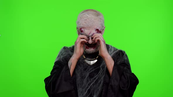 Upset Halloween Zombie Man Wipes Tears and Cries From Despair Being Sad Because of Unfair Things alt