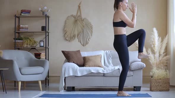 Young Fitness Woman Practicing Yoga at Home in the Morning