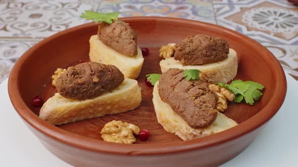 Bread Slices with Pate on Clay Plate Spinning Round on Table