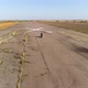 A Motorcycle with Riders of a Man and a Woman Rides at Speed on the Old Runway - VideoHive Item for Sale