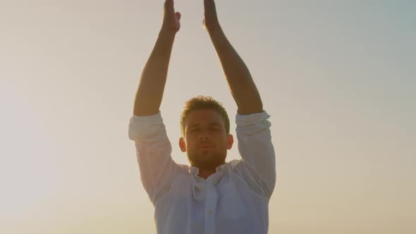 Man doing yoga on beach during sunset 4k alt