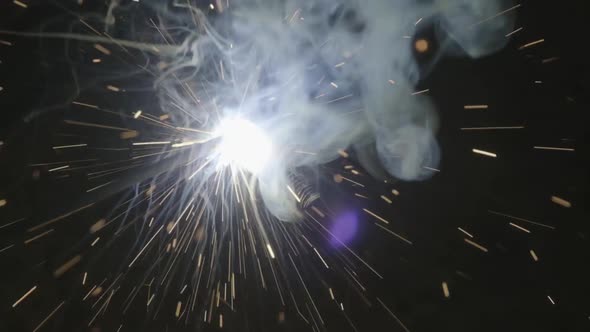 Close-up hand of Metal welder working with an arc welding machine to weld steel at the factory alt