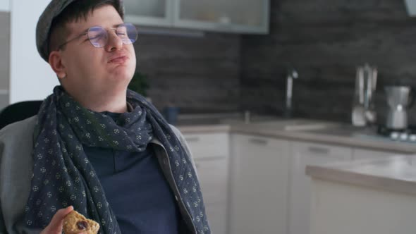 Man in Wheelchair Enjoying Cookie alt