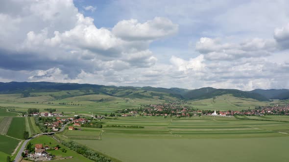 Aerial View Of Green Fields Near Houses Between Sansimion And Sanmartin Commune In Romania alt