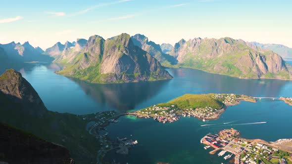 Pan Right of Reine Fishing Village with Mountains and Fjords on Lofoten Islands alt