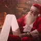 Residence of Santa Claus on North Pole, Wizard Is Reading List of Wishes, Sitting in Decorated Room - VideoHive Item for Sale