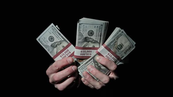 Three Stacks of 10000 American Dollars Bundles in Male Hands on Black Background alt