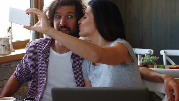 Couple taking selfie from mobile phone alt