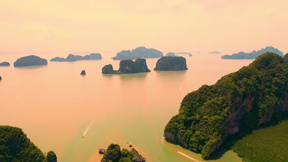 Aerial view from a drone over many islands at Phang Nga Bay during sunset time alt