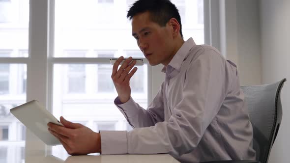 Male business professional working in a modern office alt