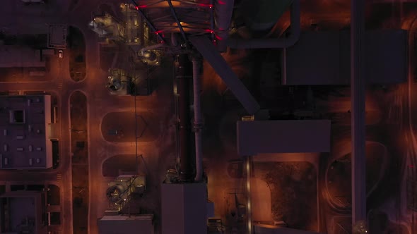  Aerial Top Down View Over Industrial Pipes At Night alt