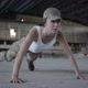 Young Woman in Military Uniform Wrings Out From the Floor on a Concrete Floor - VideoHive Item for Sale