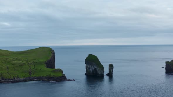 Drone Towards Drangarnir Sea Stacks In Faroe Islands alt