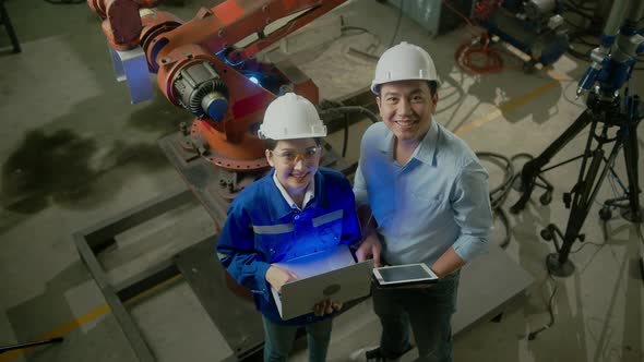 topview of asian emgineer male female technician in safty uniform alt