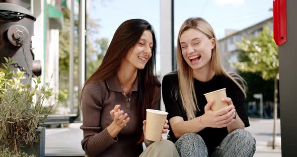 Two Friends Enjoy a Conversation with Tea and Coffee Glasses in Love Outside alt