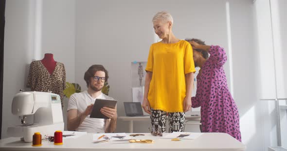 Fashion Stylist Sewing for Private Client and Fitting Clothes in Workshop alt