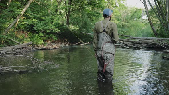 Portrait Of Fisherman Standing In River