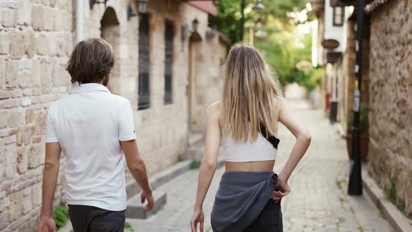 Young Traveler Couple Walking Narrow Streets in Historical Old Town alt