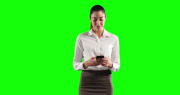 a Caucasian woman in suit using a phone in a green background