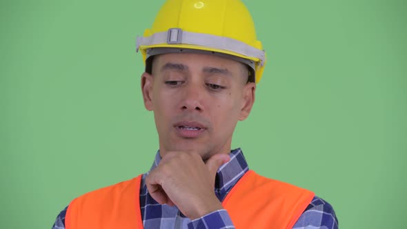 Face of Stressed Multi Ethnic Man Construction Worker Thinking alt