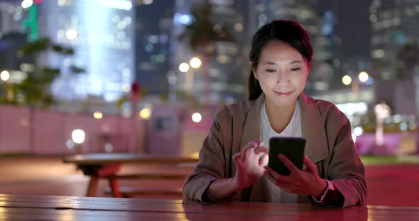 Asian business woman working on cellphone at outdoor alt
