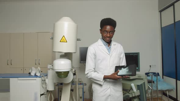 Close Up Portrait of Young African American Man Doctor in White Uniform and alt