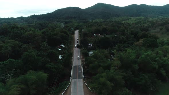 Aerial View of Countryside Road Passing Through the Lush Greenery and Foliage Tropical Rain Forest alt