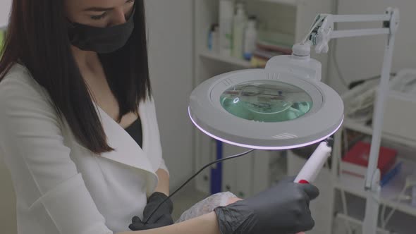 The Beautician Takes Care of the Patient's Skin with a Microinjection Procedure alt