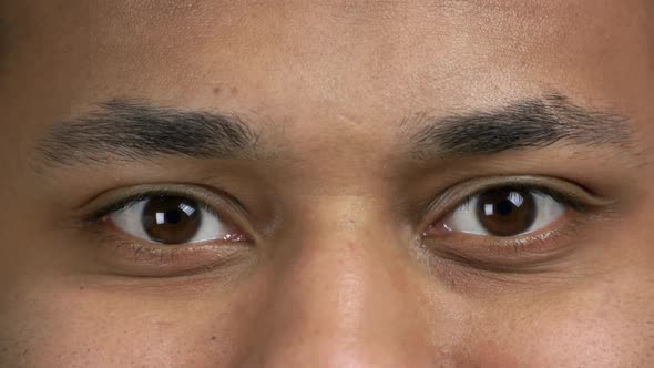Close Up Brown Eyes of Darkskinned Man alt