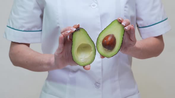 Nutritionist Doctor Healthy Lifestyle Concept - Holding Organic Avocado alt